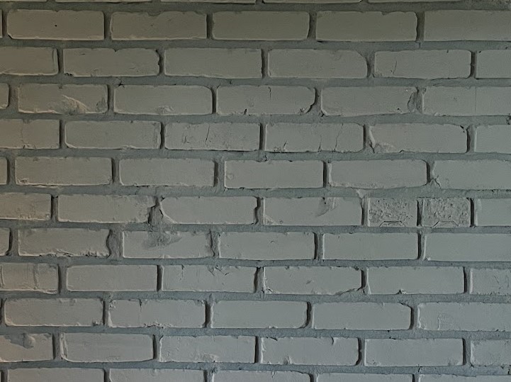 charcoal grey painted brick fireplace with chalk paint