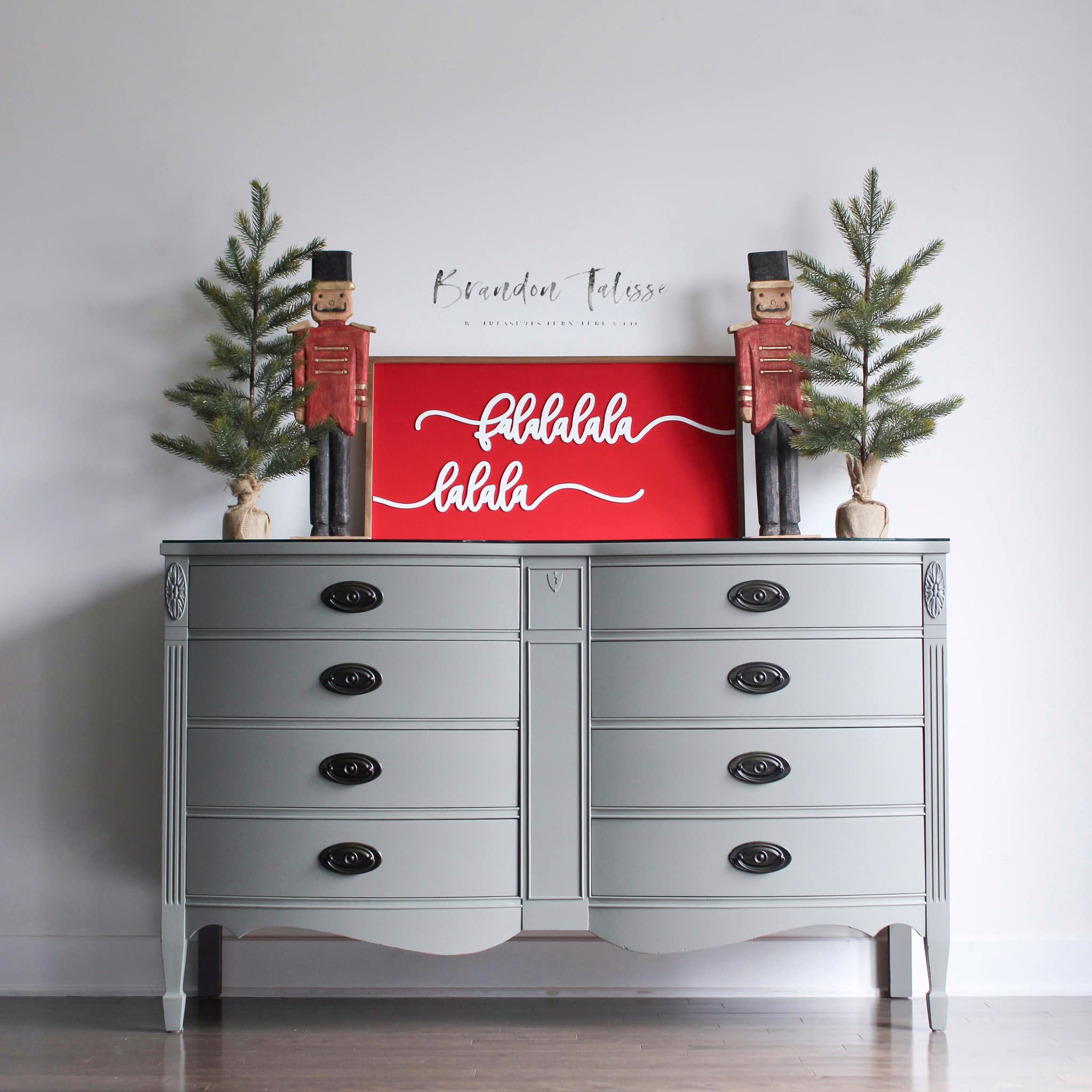 Grey painted dresser with festive christmas wood sign and mini christmas tree decor on top