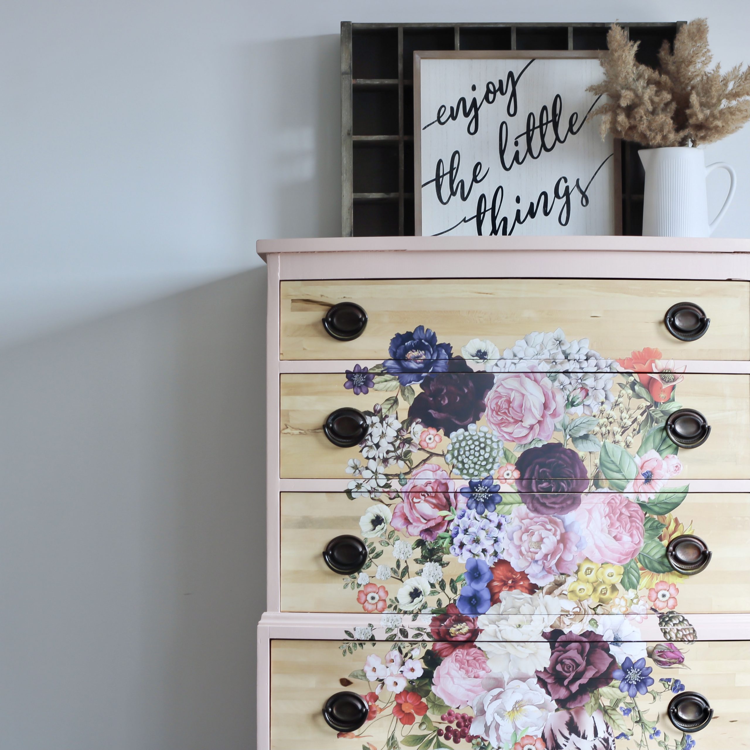 tall dresser in pale pink with floral transfer and pewter hardware