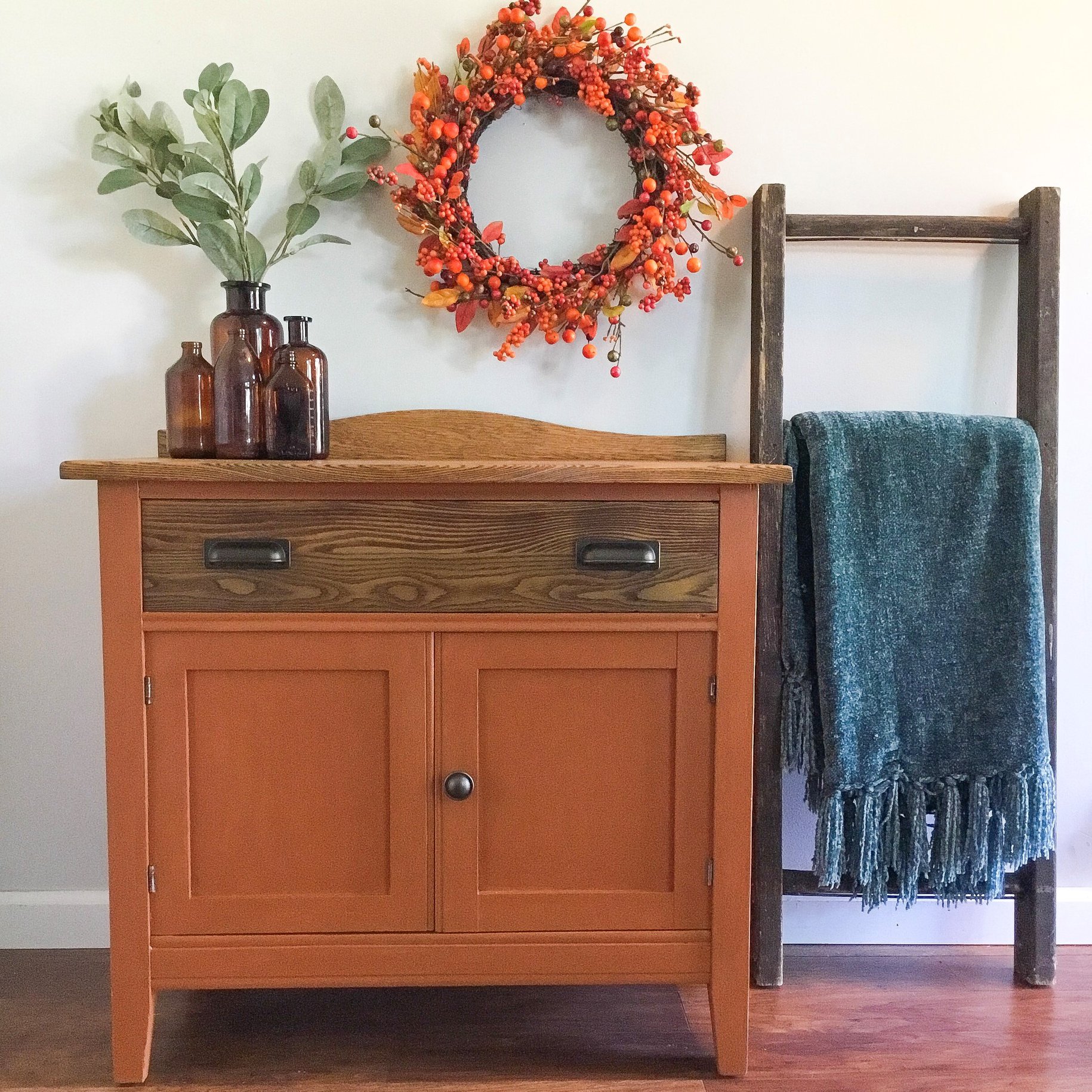 Farmhouse Cabinet in With A Twist with Stained Wood Drawer and Wreath